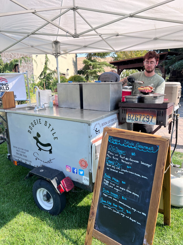 Outdoor gourmet hot dog stand with vendor