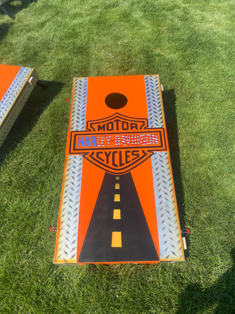 Harley-Davidson themed cornhole board on grass