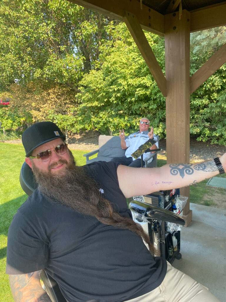 Two men relaxing under gazebo outdoors