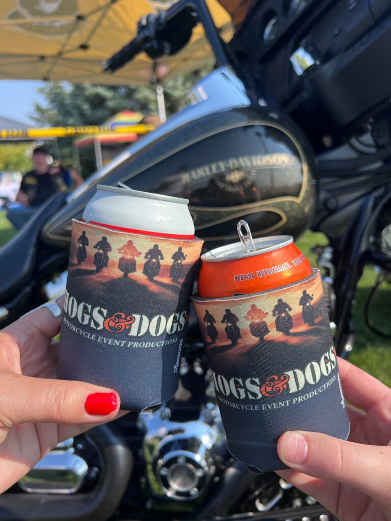 Drinks raised beside Harley-Davidson at motorcycle event