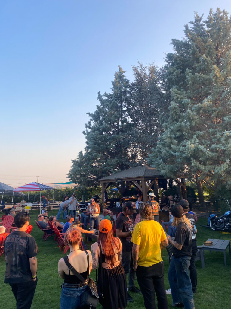 Outdoor gathering near gazebo at sunset